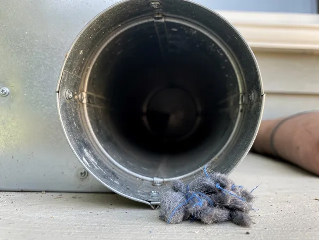 Country Club Dryer Vent Cleaning technician using specialized equipment to clear severe dryer vent blockage in Country Club
